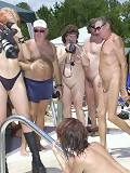 Big group of family nudists having party in the pool